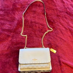Beautiful like new off-white.Coach crossbody with 2 outside pockets.
